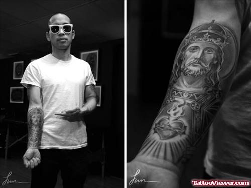 Man Showing His Jesus Tattoo On Forearm