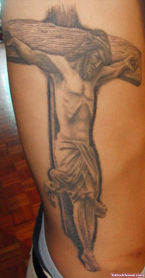 Grey Ink Cross And Jesus Tattoo On Side Rib