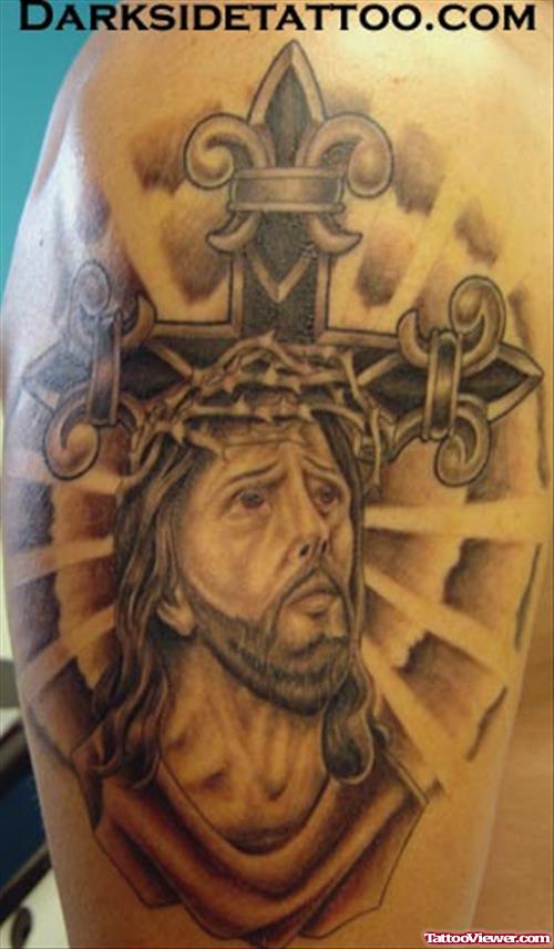 Grey Ink Cross And Jesus Tattoo On Shoulder