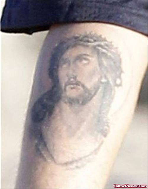 Grey Ink Jesus Tattoo On Biceps