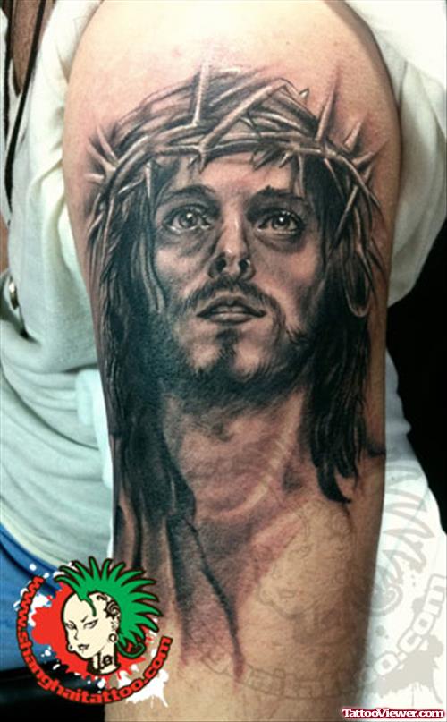Black Ink Jesus Portrait Tattoo On Left Bicep
