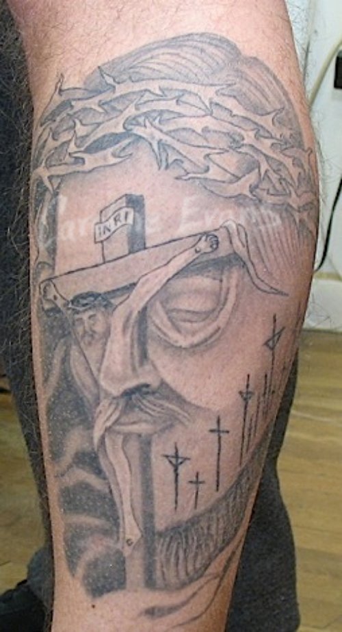 Grey Ink Cross And Jesus Head Tattoo On Sleeve