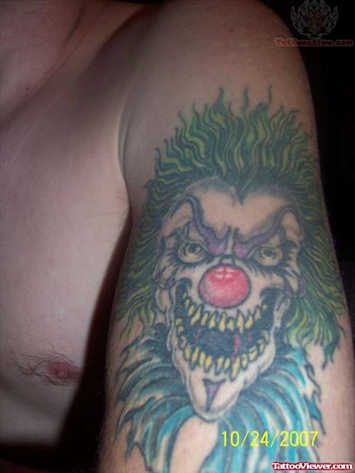 Red Nose Joker Tattoo On Muscles