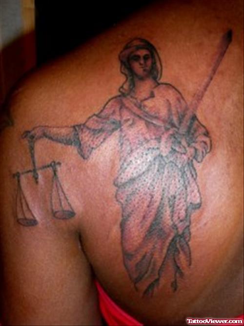 Justice Tattoo On Left Back Shoulder