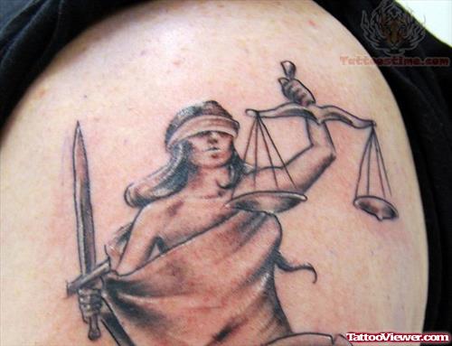 Grey Ink Justice Tattoo On Shoulder