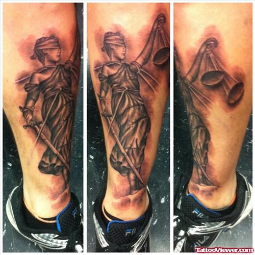 Grey Ink Justice Tattoo On Leg