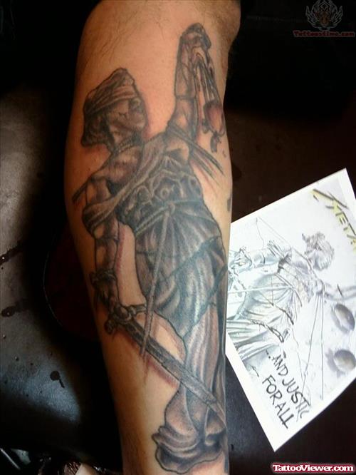 Dark Ink Justice Tattoo On Leg
