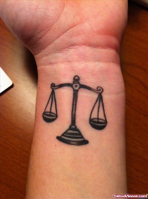 Black Ink Justice Balance Tattoo On Wrist
