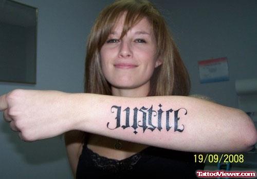 Ambigram Justice Tattoo On Left Arm