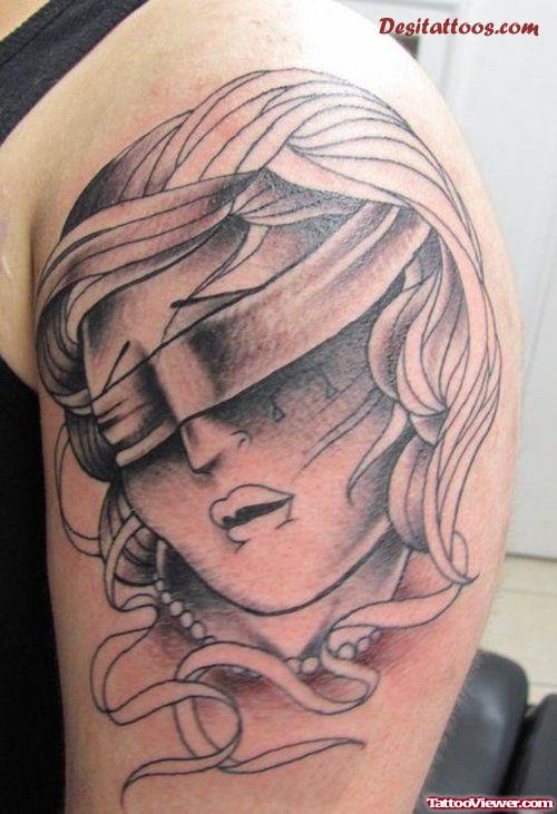 Grey Ink Justice Tattoo On Left Shoulder