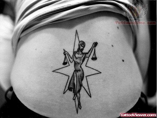 Justice Grey Ink Tattoo On Lower Back