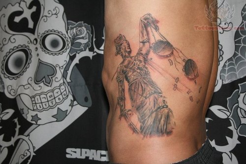 Justice Tattoo On Man Left Rib side