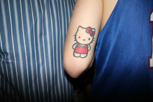 Colored Kitty Tattoo On Girl Bicep
