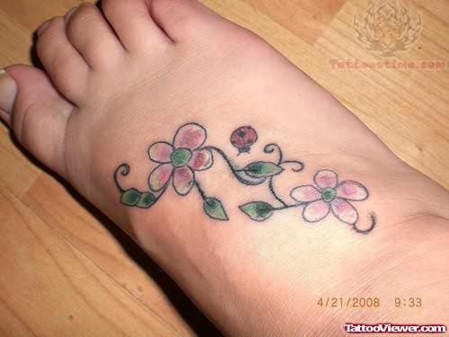 Flowers And Ladybug Tattoo On Foot