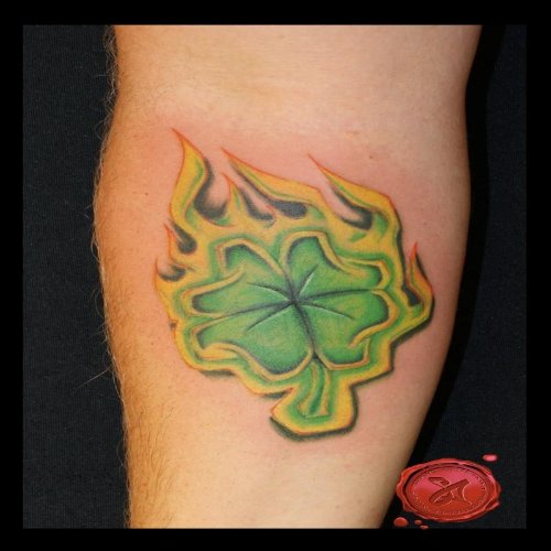 Green Ink Flaming Leaf Tattoo On Arm