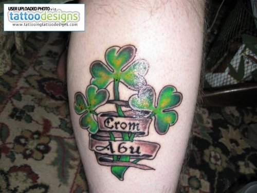 Banners And Green Clover Leaf Tattoo On Leg