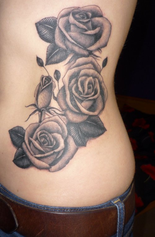 Grey Rose Flowers And Leaf Tattoo On Side Rib