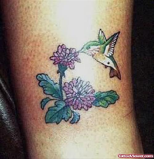 Nice Flowers And Flying Hummingbird Leg Tattoo
