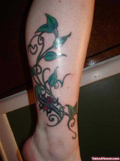 Tribal Rose And Green Leaves Leg Tattoo