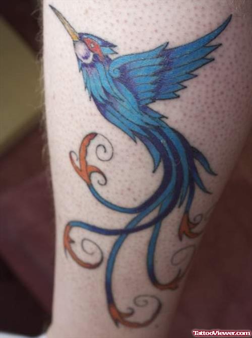 Blue Ink Flying Hummingbird Leg Tattoo