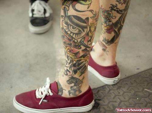 Grey Ink Dagger And Eye Leg Tattoo