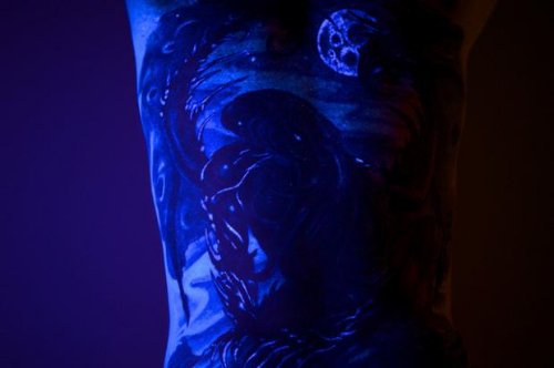 Blue Ink Light Tattoo On Sleeve