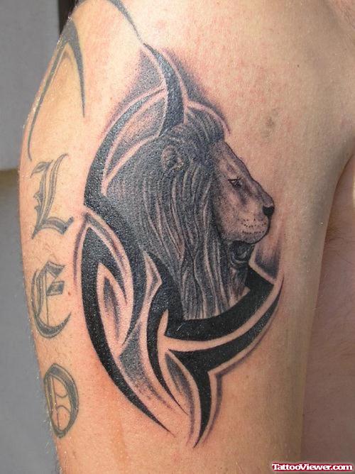 Black Tribal And Lion Tattoo On Leg