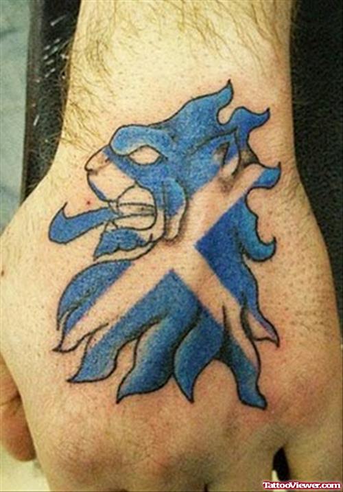 Blue Ink Lion Tattoo On Left Hand