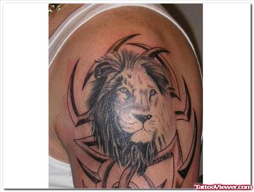 Grey Ink Tribal And Lion Head Tattoo On Shoulder