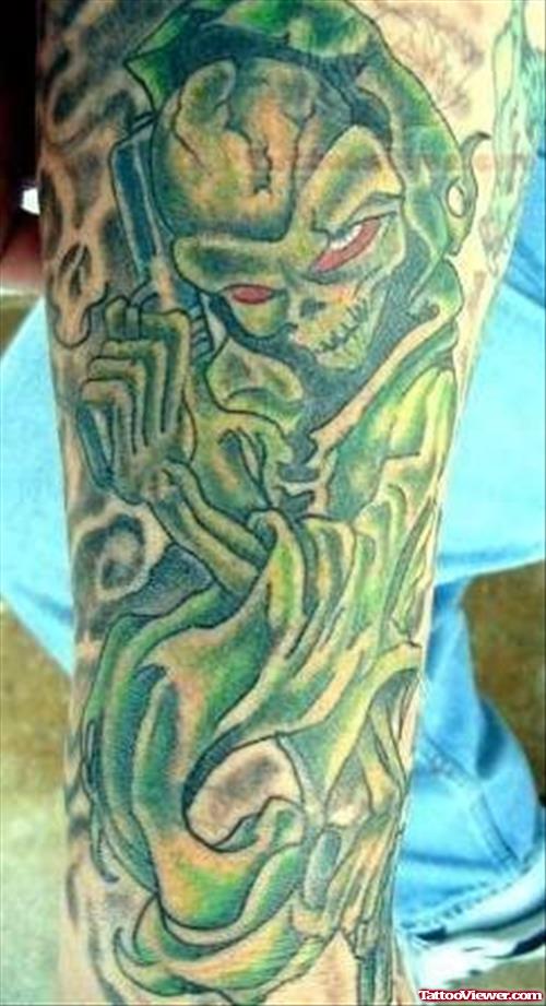 Green Ink Monster Tattoo On Arm