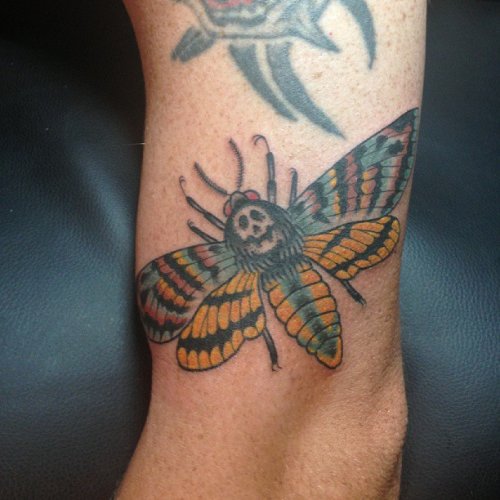 Beautiful Left Bicep Moth Tattoo