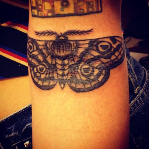 Left Arm Grey Ink Moth Tattoo On Arm