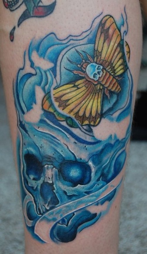Blue Ink Skull And Moth Tattoo
