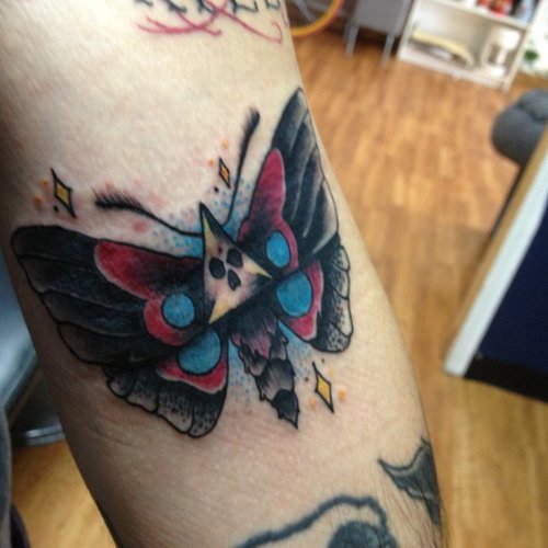 Fine Colored Ink Moth Bicep Tattoo