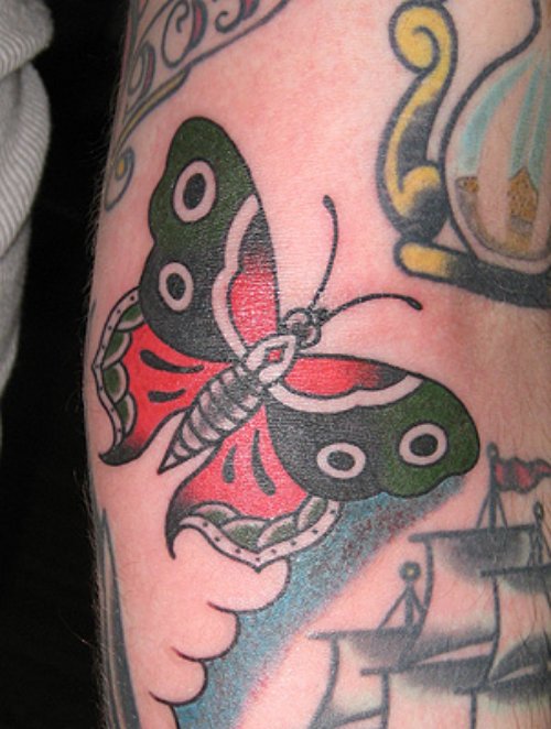 Amazing Red And Black Ink Moth Tattoo