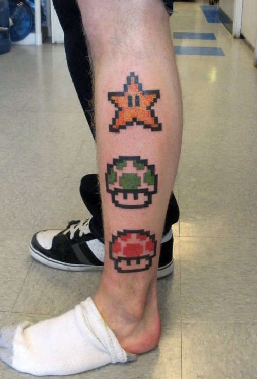 Mario Mushrooms And Star Tattoo On Leg