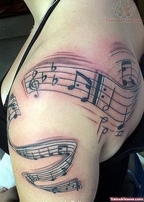 Music Tattoo On Bicep And Back