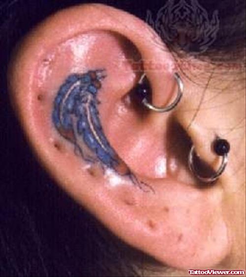 Blue Native American Tattoo Inside Ear