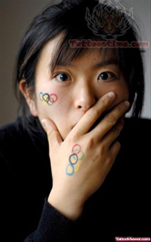 Colorful Olympic Tattoos On Hand And Cheek