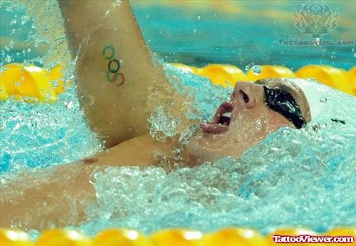 Olympic Tattoo On Swimmer Bicep