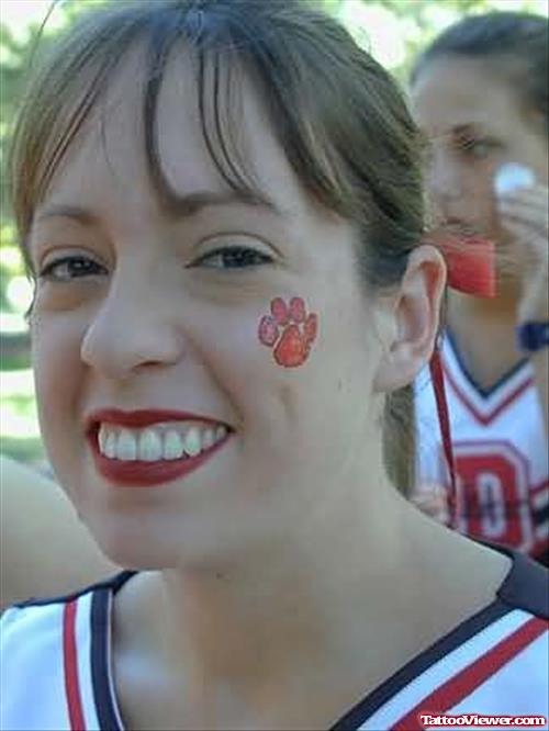 Paw Red Ink Tattoo On Face