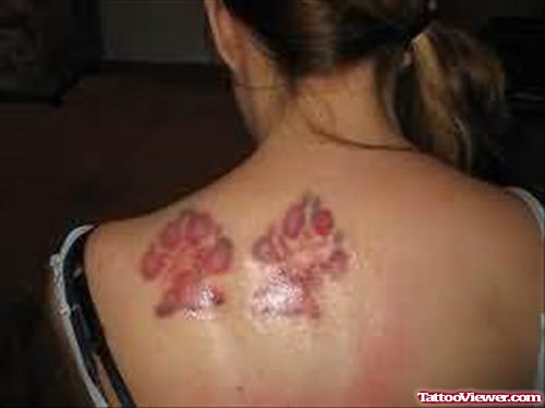Red Paw Print Tattoos On Back