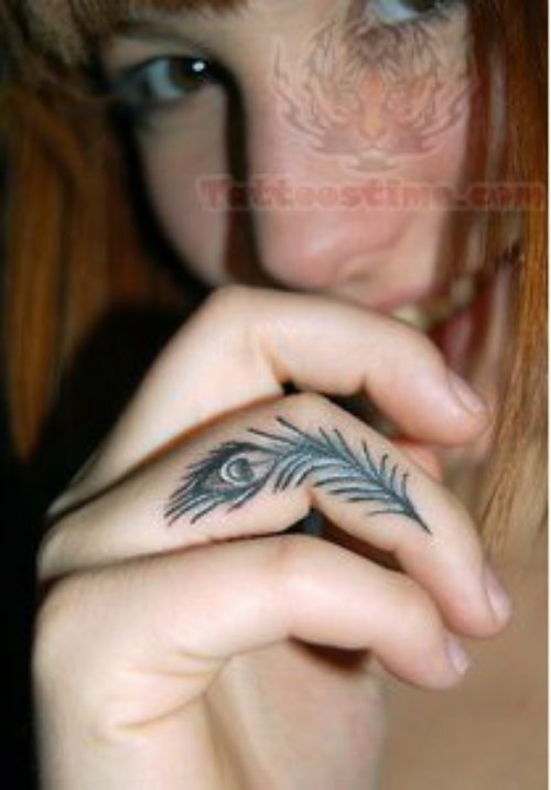 Tiny Peacock Feather Tattoo On Finger