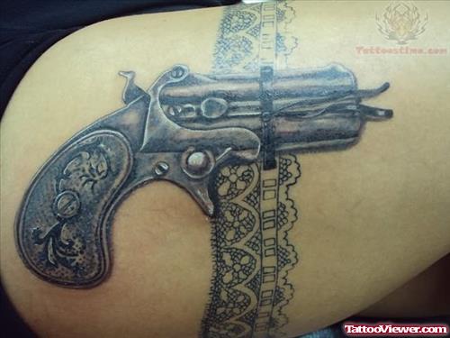 Small Pistol Tattoo On Shoulder