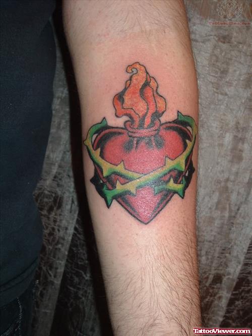 Burning Sacred Heart Tattoo On Arm