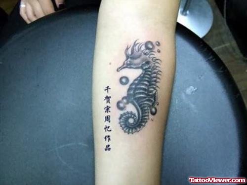 Black Seahorse Tattoo On Arm