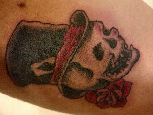 Red Rose And Skull With Black Hat Tattoo