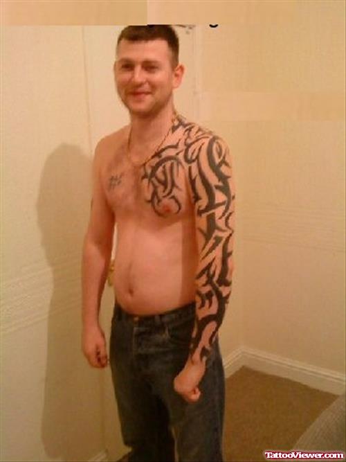 Tribal Chest And Sleeve Tattoo For Men