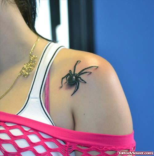 Realistic black spider tattoo on shoulder