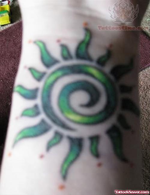 Green ink Sun Tattoo On Wrist